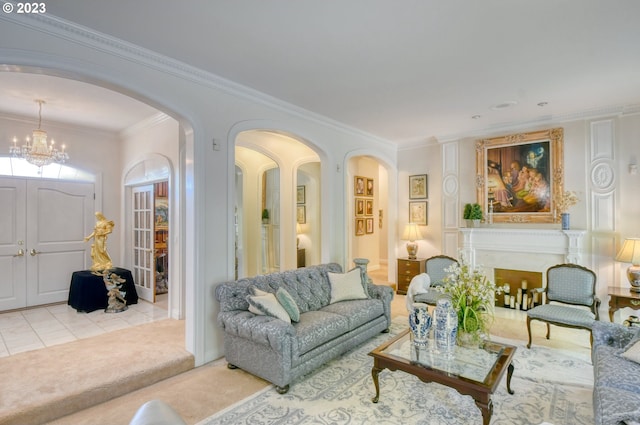 living room with ornamental molding, a chandelier, and light colored carpet