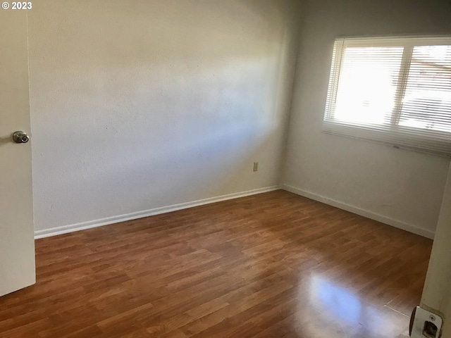 spare room featuring dark hardwood / wood-style floors