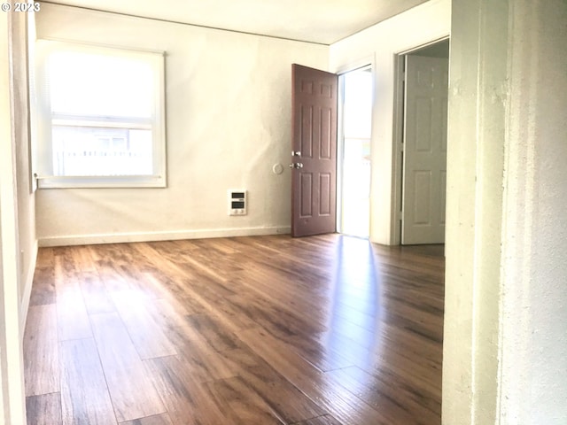 empty room featuring dark wood-type flooring