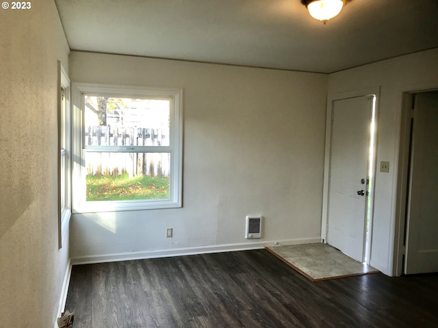 unfurnished room featuring dark hardwood / wood-style floors