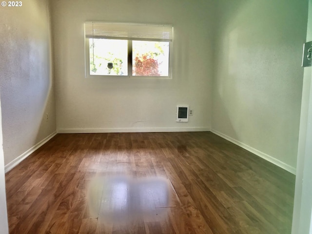 unfurnished room featuring dark hardwood / wood-style flooring