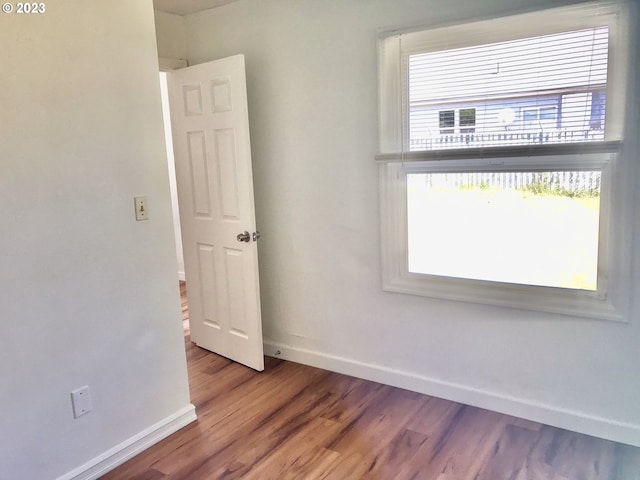 spare room with wood-type flooring