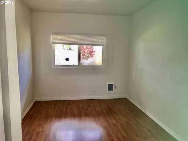 unfurnished room with dark hardwood / wood-style floors