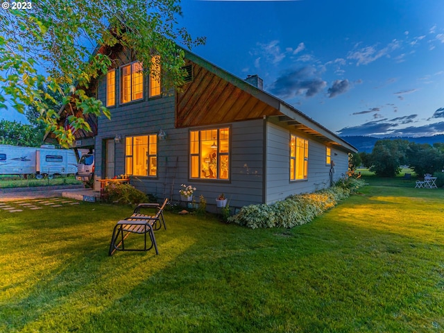 back house at dusk with a yard