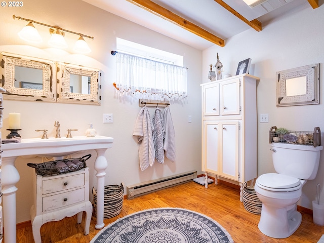 bathroom with toilet, a baseboard radiator, beamed ceiling, and wood-type flooring