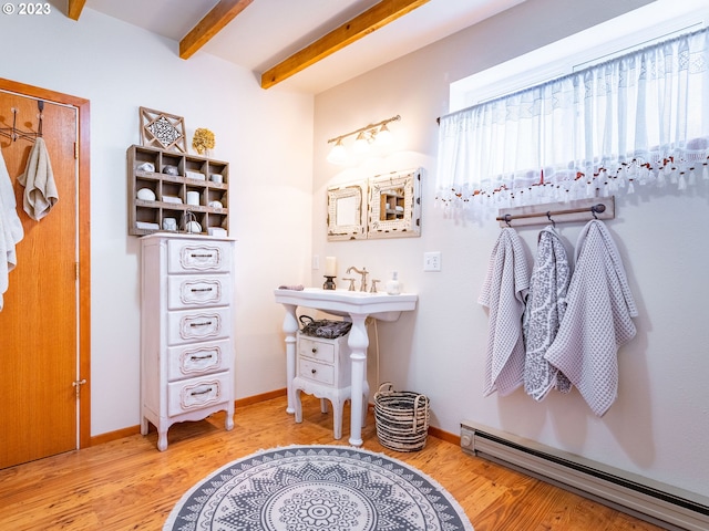 bathroom featuring beam ceiling, a baseboard radiator, and wood-type flooring