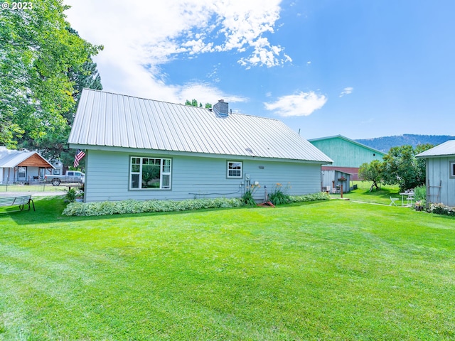 rear view of property with a lawn