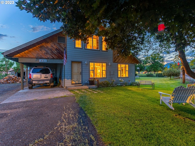 view of front facade with a lawn and a carport