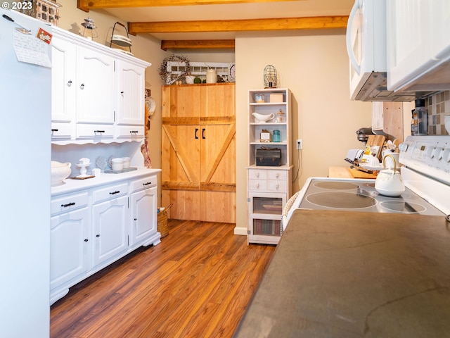 kitchen featuring beam ceiling, stove, dark wood-type flooring, white cabinetry, and fridge