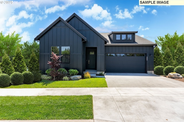 view of front of property with a garage and a front yard