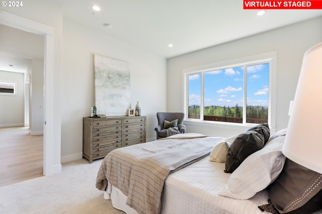 bedroom featuring light carpet