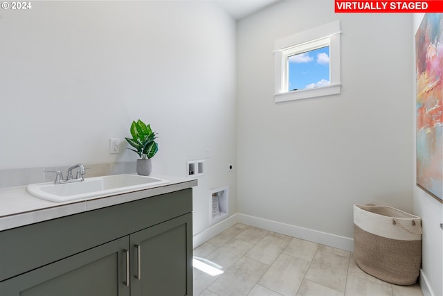 clothes washing area with cabinets, washer hookup, hookup for an electric dryer, and sink