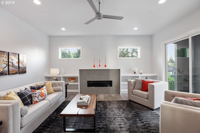 living room featuring dark hardwood / wood-style floors, a healthy amount of sunlight, and ceiling fan