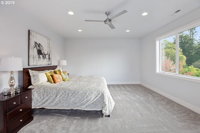 bedroom with ceiling fan and dark colored carpet