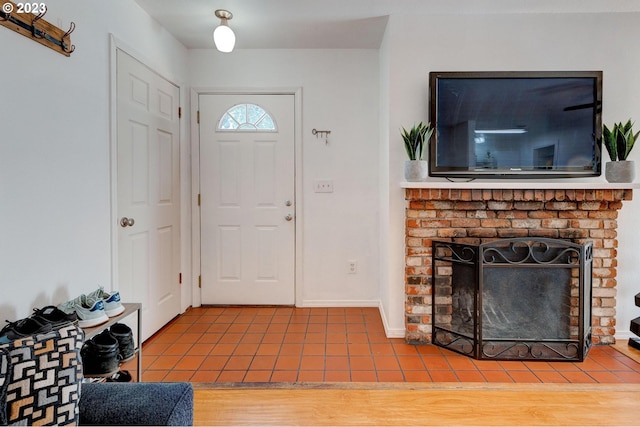 tiled entryway with a fireplace