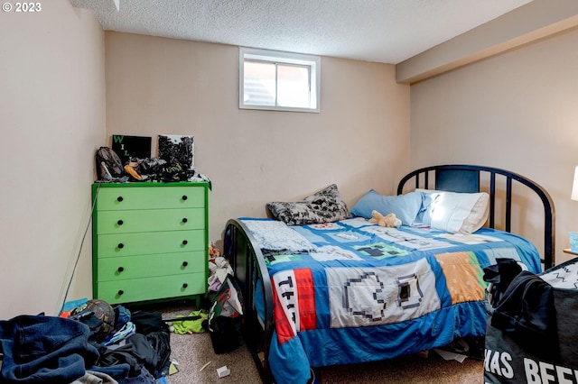 bedroom with dark carpet and a textured ceiling