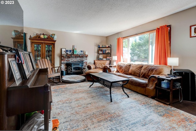 living room featuring dark hardwood / wood-style floors, a textured ceiling, and a fireplace