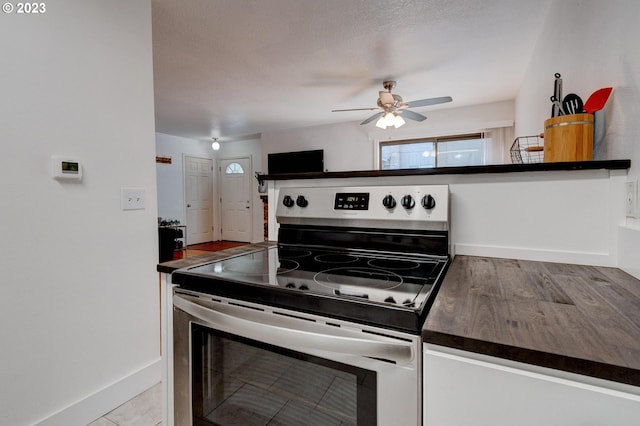 kitchen featuring electric stove, ceiling fan, and light tile floors