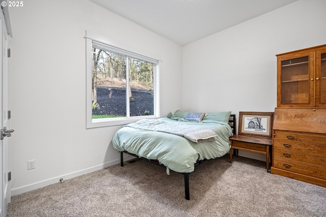 bedroom with carpet flooring, baseboards, and vaulted ceiling