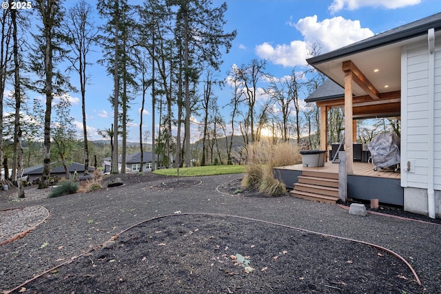 view of yard featuring a deck with mountain view