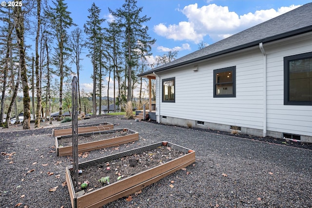 view of side of property with a garden