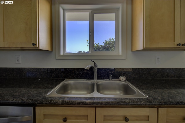 kitchen with dishwashing machine, light brown cabinets, and sink