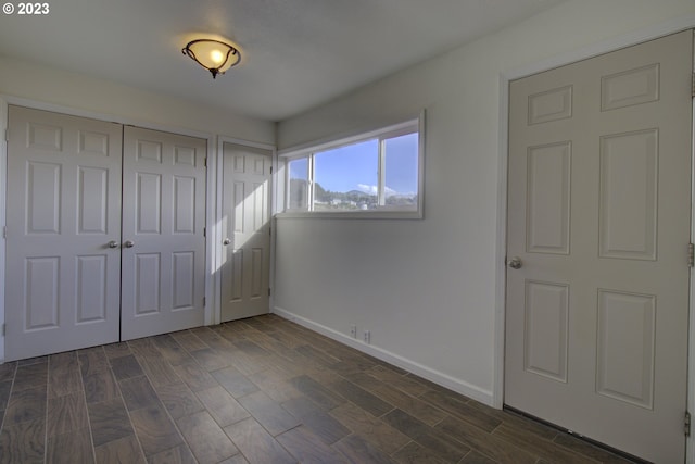 unfurnished bedroom featuring dark wood-type flooring