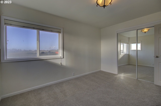 unfurnished bedroom featuring a closet and carpet floors