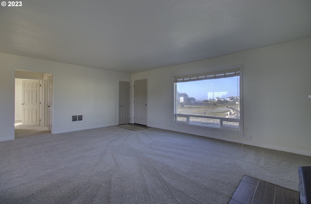 unfurnished room with light colored carpet