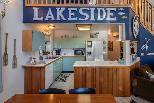 kitchen with white appliances, sink, and light tile floors