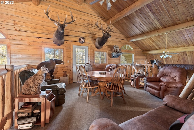 carpeted living room with ceiling fan, wooden walls, wooden ceiling, and vaulted ceiling with beams