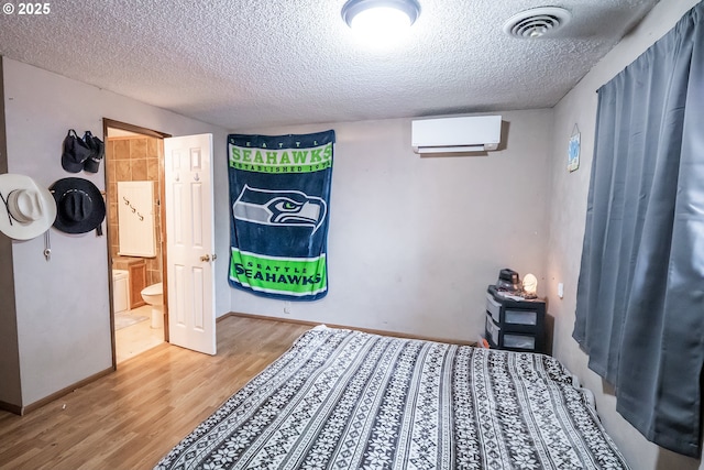 5360 B St, Springfield, OR 97478 - bedroom with a wall mounted air conditioner, wood finished floors, and a textured ceiling
