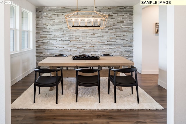 dining room featuring a notable chandelier and dark hardwood / wood-style flooring