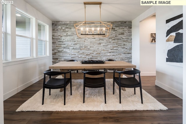 dining space with a chandelier and dark hardwood / wood-style floors