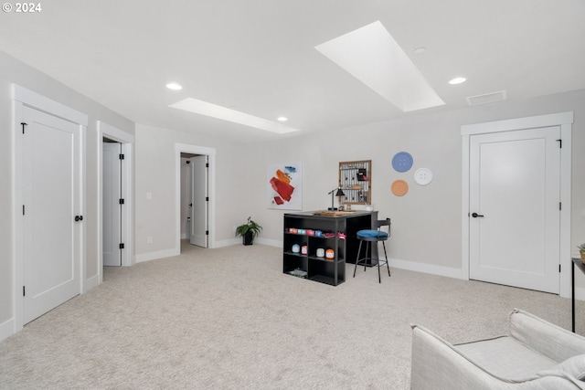 interior space with a skylight and light carpet