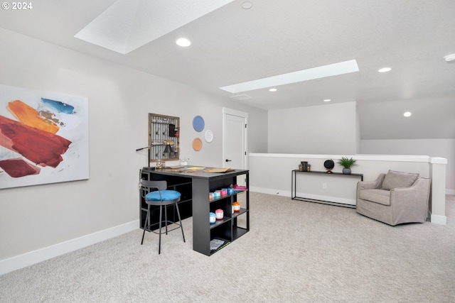 office area featuring light colored carpet and a skylight