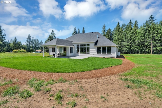 back of house with a patio and a yard