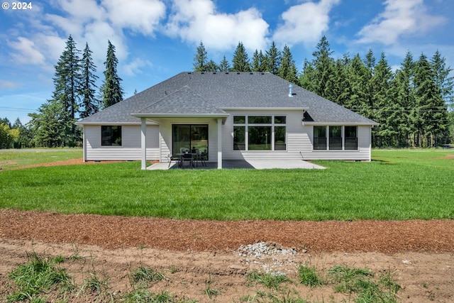 rear view of house featuring a patio and a yard