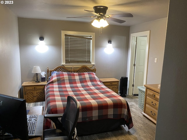 bedroom with ceiling fan and dark hardwood / wood-style floors