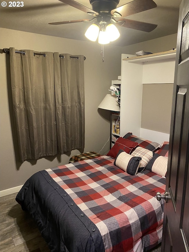 bedroom featuring ceiling fan and dark hardwood / wood-style floors