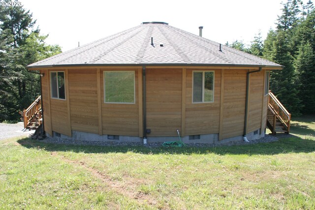 view of side of home with a yard