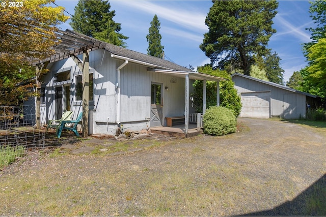 view of front of property featuring a garage and an outdoor structure