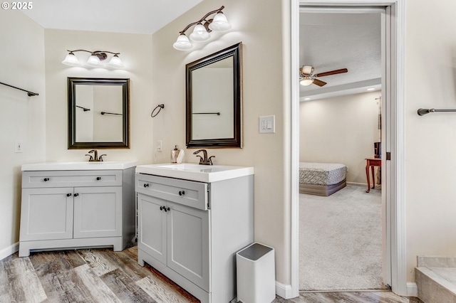 2940 Robinwood Dr, Forest Grove, OR 97116 - full bath with two vanities, ceiling fan, baseboards, and wood finished floors