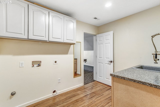 2940 Robinwood Dr, Forest Grove, OR 97116 - laundry area with light wood-style floors, cabinet space, baseboards, electric dryer hookup, and washer hookup