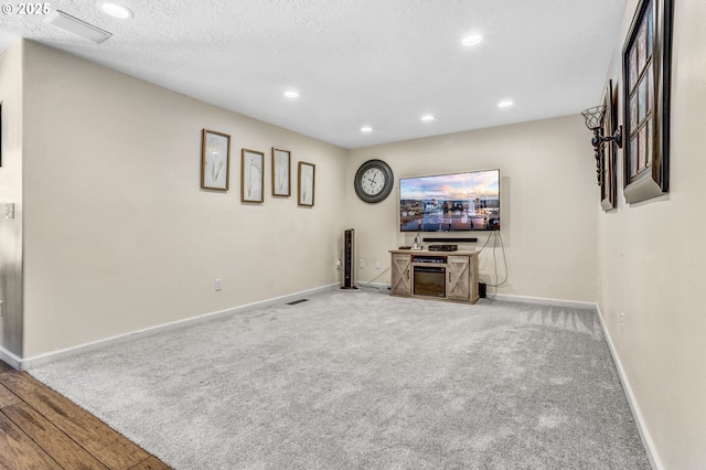 2940 Robinwood Dr, Forest Grove, OR 97116 - unfurnished living room with baseboards, recessed lighting, carpet, wood finished floors, and a textured ceiling
