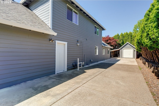 2940 Robinwood Dr, Forest Grove, OR 97116 - view of home's exterior with concrete driveway, a garage, roof with shingles, and a patio
