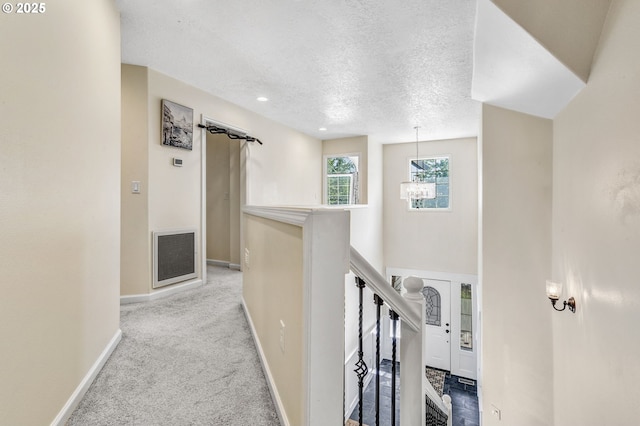 2940 Robinwood Dr, Forest Grove, OR 97116 - hallway with a textured ceiling, baseboards, an upstairs landing, carpet flooring, and a chandelier