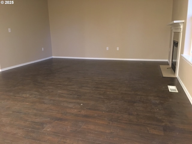 empty room with dark hardwood / wood-style floors