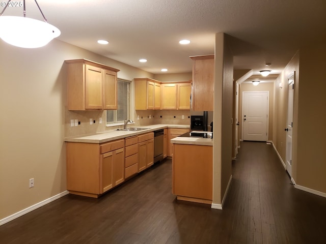 kitchen featuring light brown cabinetry, decorative light fixtures, sink, stainless steel dishwasher, and dark wood-type flooring