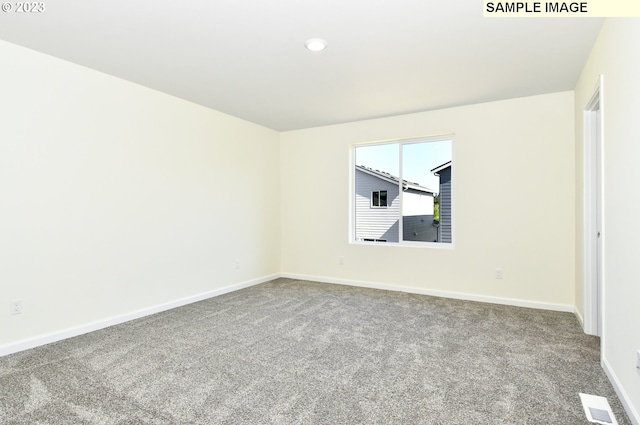 spare room featuring light colored carpet